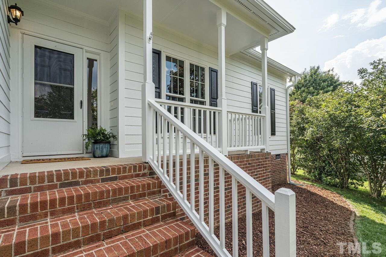 3008 Agent Court Raleigh, NC 27603 - Photo 2 of 28 Inviting front porch with storm door! Seller replaced all exterior gutters in 2021!