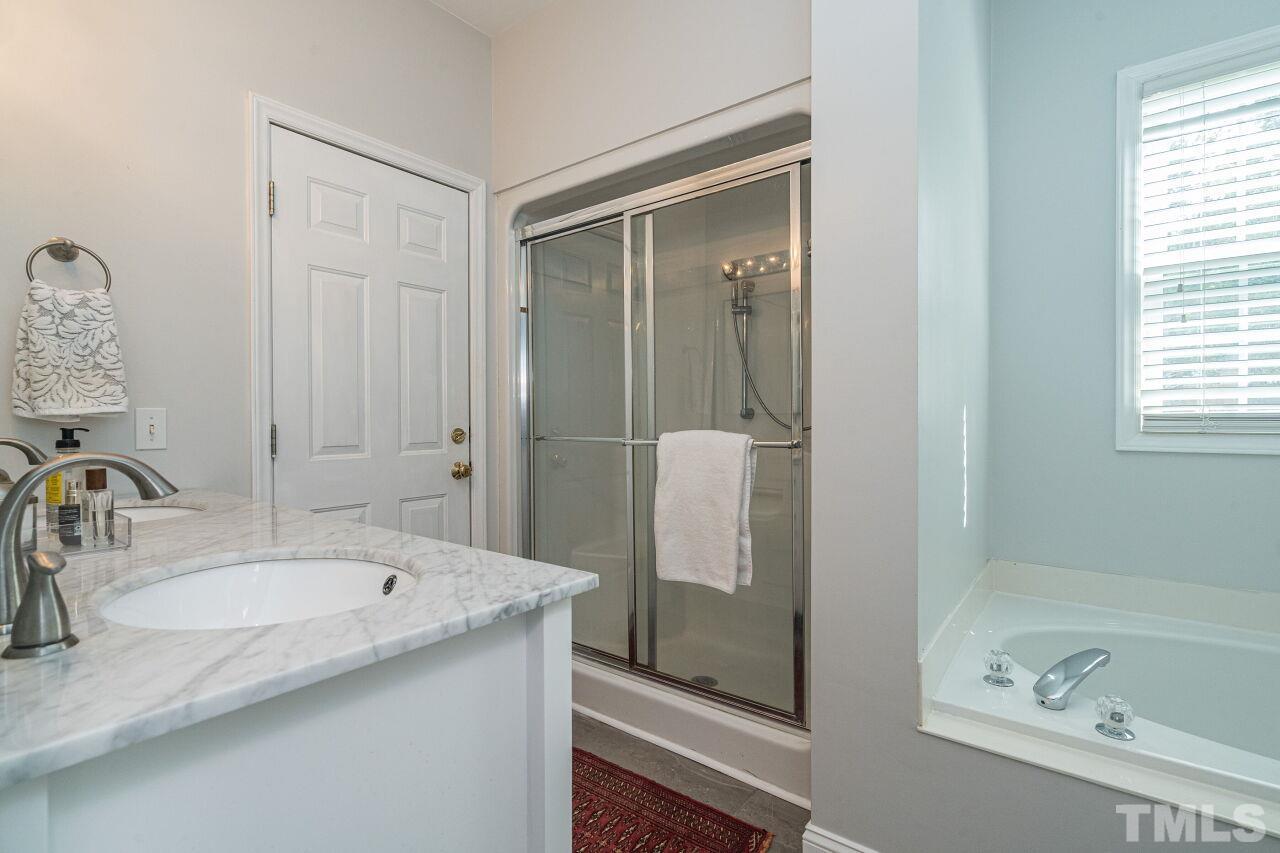 3008 Agent Court Raleigh, NC 27603 - Photo 15 of 28 Master bathroom was updated with vanity, floors, toilet, paint and baseboards in 2019!