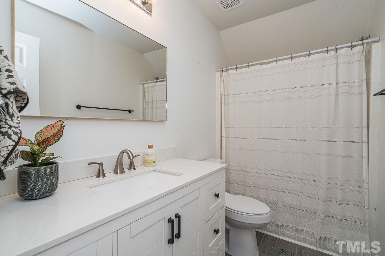 3008 Agent Court Raleigh, NC 27603 - Photo 21 of 28 Another eye-catching + recently updated bathroom with new vanity, floors, toilet, paint and baseboards.