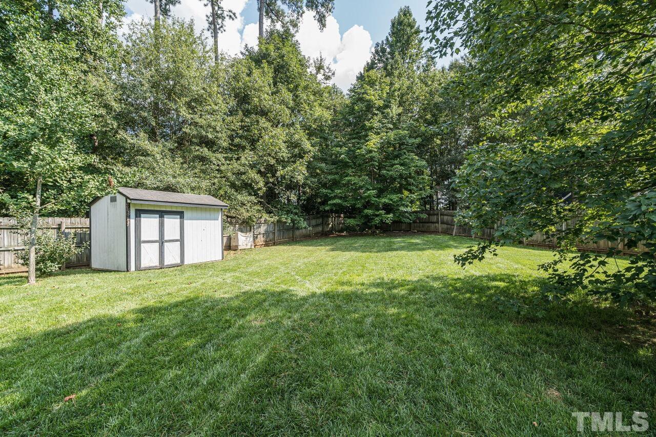 3008 Agent Court Raleigh, NC 27603 - Photo 25 of 28 Private backyard with fence and handy storage unit.