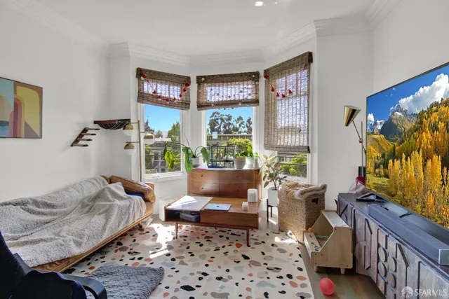a living room with furniture and a floor to ceiling window