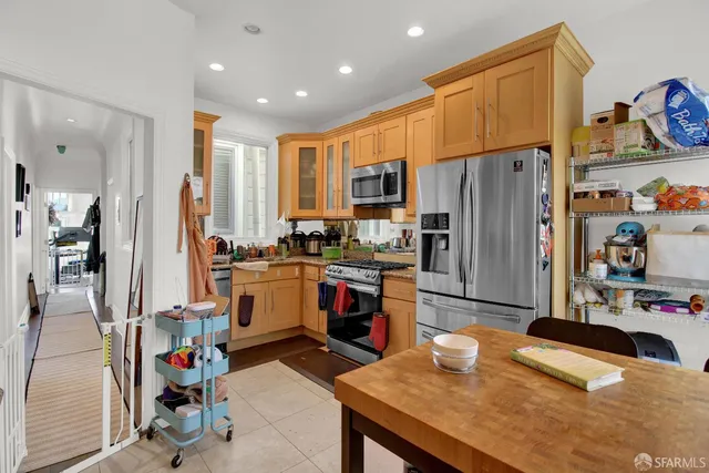 a kitchen with a refrigerator a stove and a refrigerator