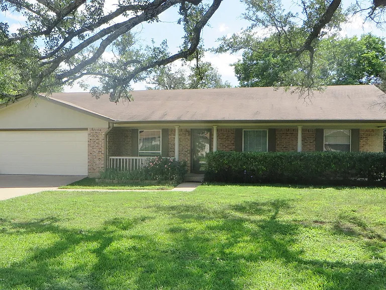 103 Spanish Oak Circle Georgetown, TX 78628 - Photo 1 of 12 Single story home with brick siding, an attached garage, a front yard, and concrete driveway
