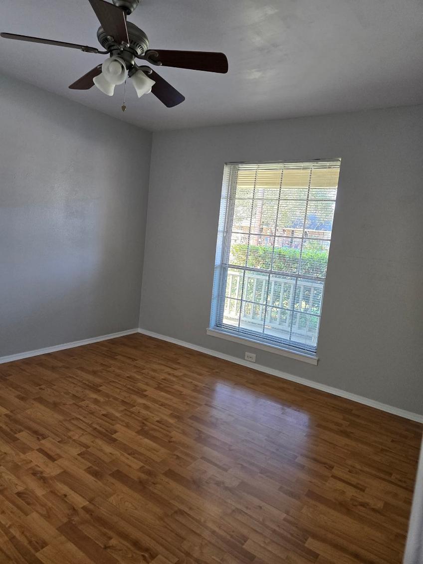 103 Spanish Oak Circle Georgetown, TX 78628 - Photo 8 of 12 Unfurnished room featuring a ceiling fan and dark wood-type flooring