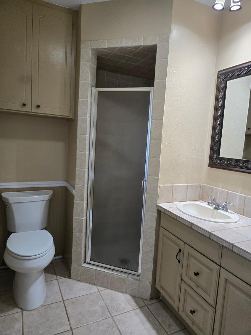 103 Spanish Oak Circle Georgetown, TX 78628 - Photo 10 of 12 Full bathroom with vanity, a stall shower, and light tile patterned flooring