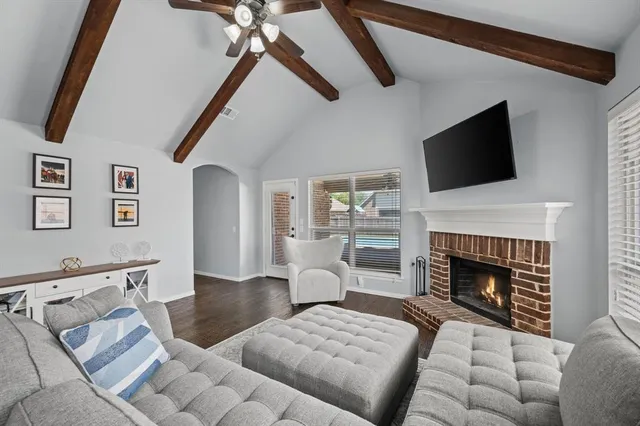 a living room with furniture a fireplace and a flat screen tv
