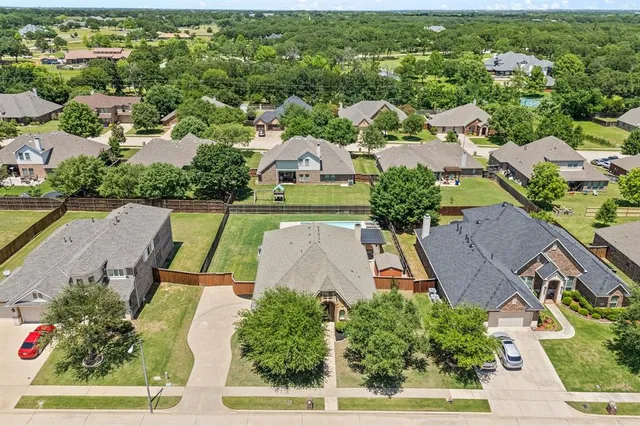 an aerial view of multiple houses with yard