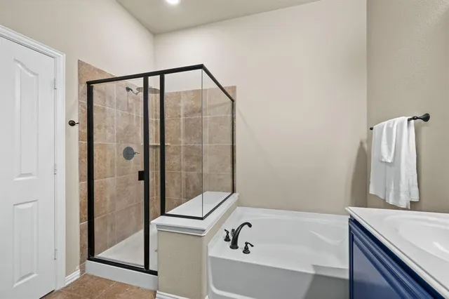 a spacious bedroom with a bed a couch and window