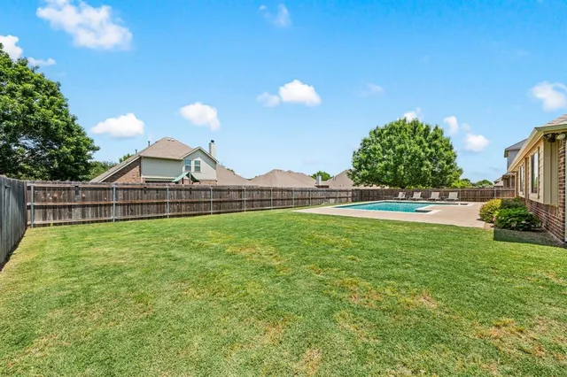 a view of a house with backyard porch and sitting area