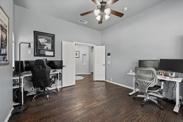 a view of a workspace with wooden floor