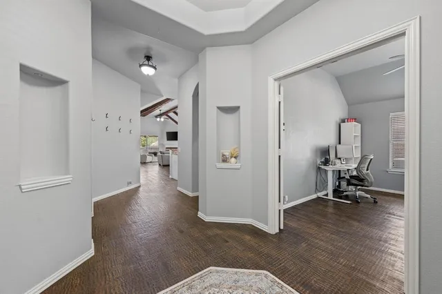 a view of a hallway with wooden floor and a living room