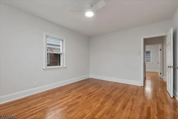 a view of a livingroom with wooden floor and window