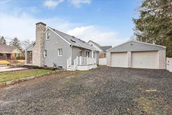 a view of a house with a backyard and a garage