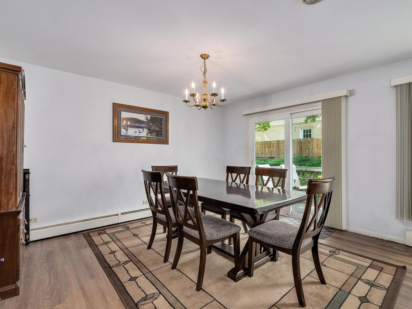 S374 Summit Drive Winfield, IL 60190 - Photo 4 of 17 a dining room with furniture a rug and a chandelier