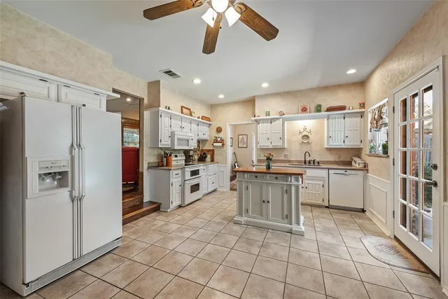 a kitchen with stainless steel appliances a refrigerator sink and cabinets