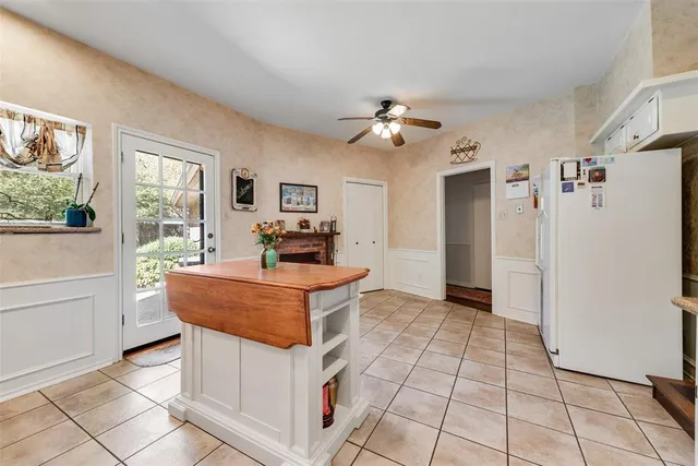 a living room with granite countertop furniture a flat screen tv and a window