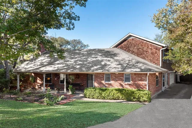 a front view of a house with a yard table and chairs