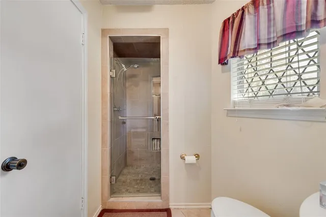 a bathroom with a shower and toilet