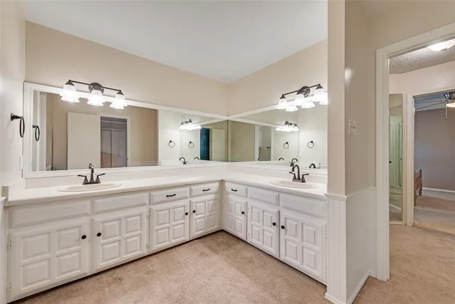a spacious bathroom with a double vanity sink double and mirror