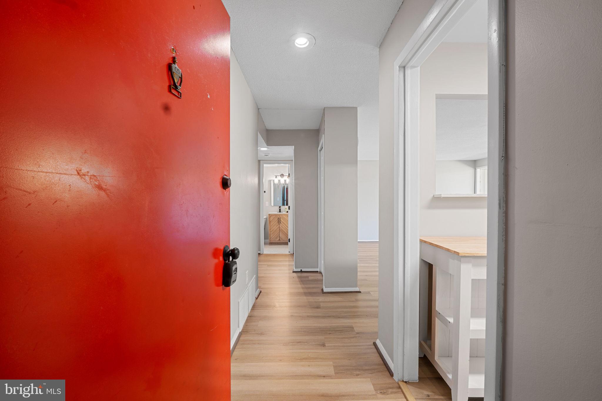 7204 Donnell Place, Unit C5 District Heights, MD 20747 - Photo 11 of 27 a view of a hallway with wooden floor and a bathroom