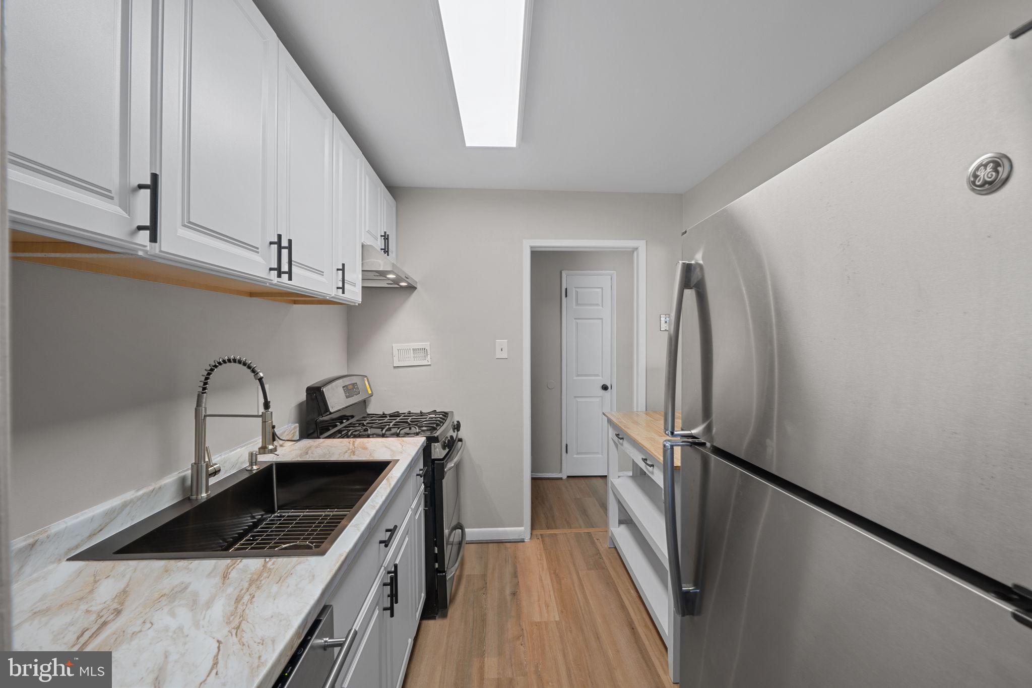 7204 Donnell Place, Unit C5 District Heights, MD 20747 - Photo 14 of 27 a kitchen with stainless steel appliances granite countertop a refrigerator and a sink