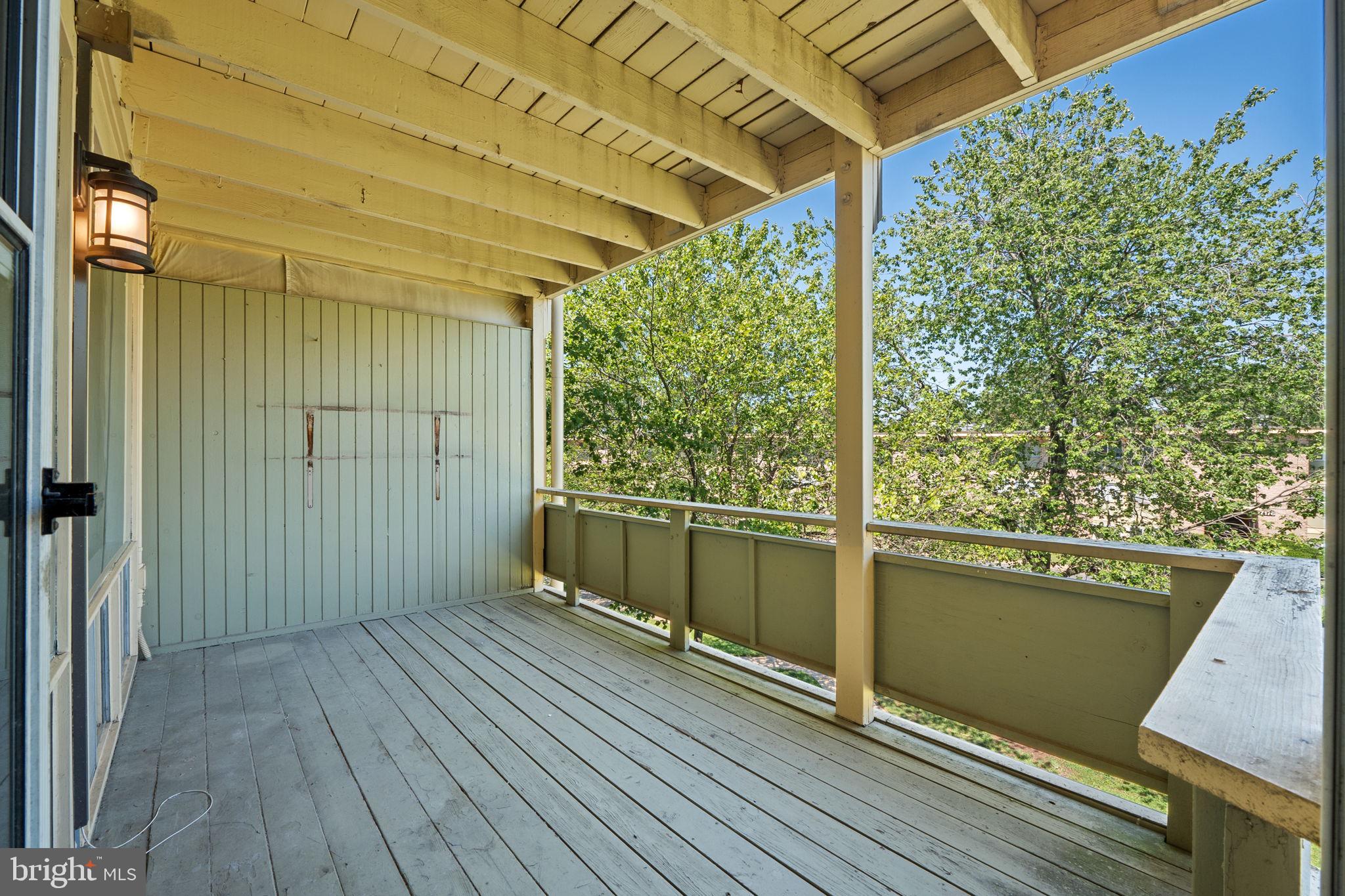 7204 Donnell Place, Unit C5 District Heights, MD 20747 - Photo 19 of 27 a view of a balcony with wooden floor