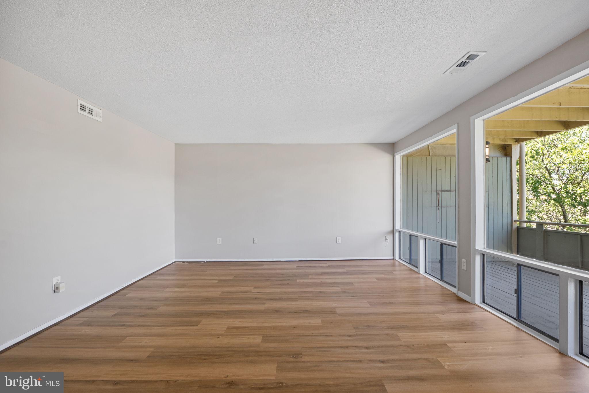 7204 Donnell Place, Unit C5 District Heights, MD 20747 - Photo 23 of 27 a view of an empty room with wooden floor and a window