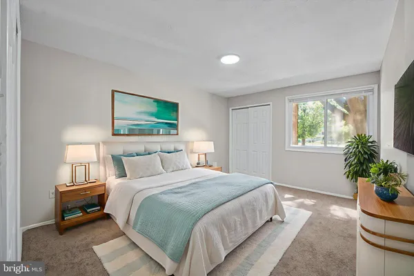 a bedroom with bed and a potted plant