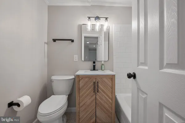 a bathroom with a toilet a sink and mirror