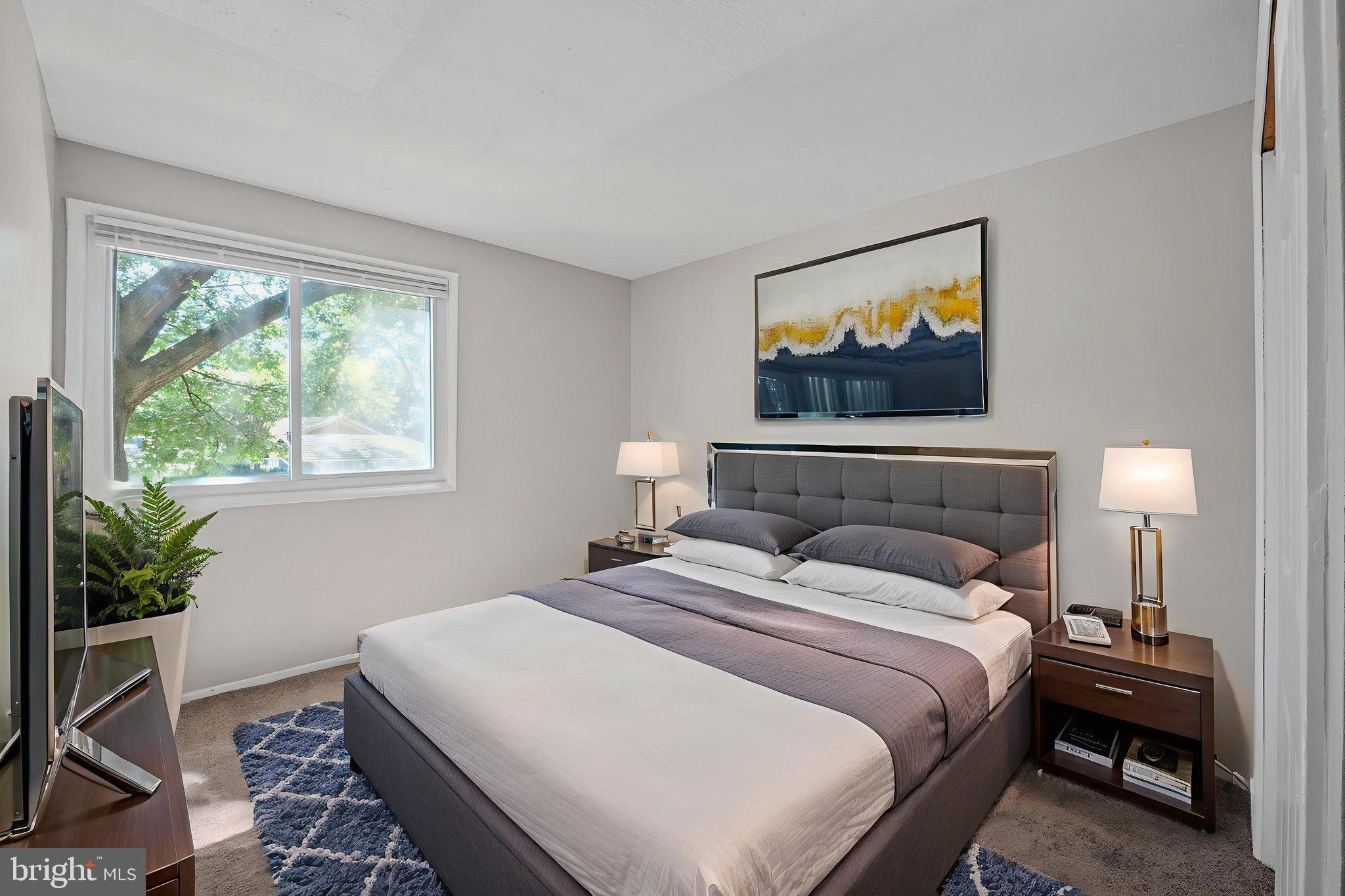 7204 Donnell Place, Unit C5 District Heights, MD 20747 - Photo 9 of 27 a bedroom with a bed and a flat screen tv