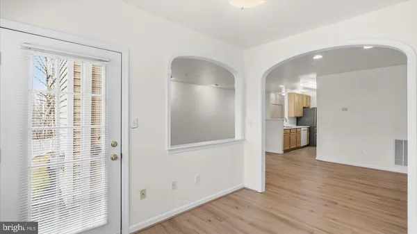 a view of empty room with wooden floor and windows