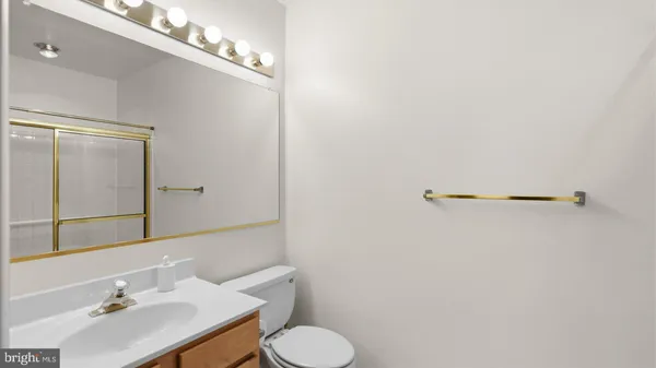 a bathroom with a sink mirror and toilet