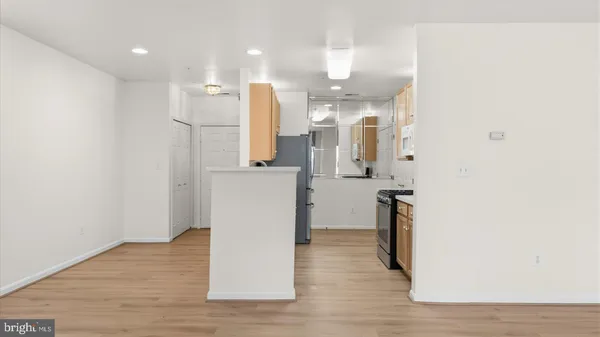 a view of a kitchen with a refrigerator and a sink