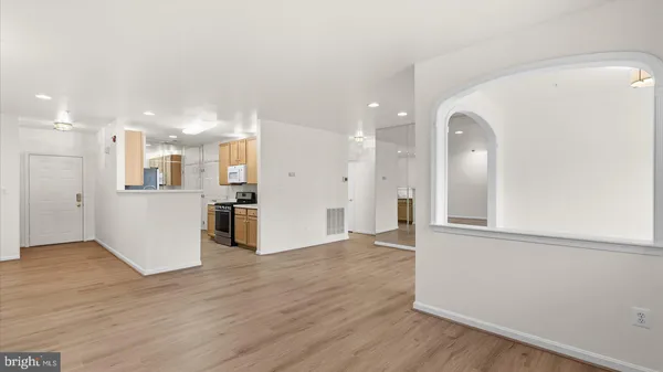 a view of a kitchen with wooden floor and a kitchen