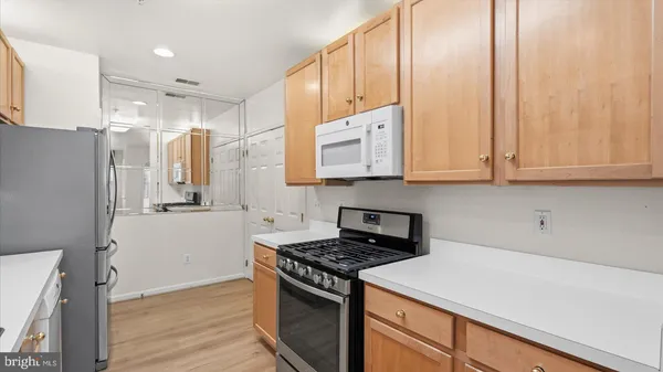 a kitchen with stainless steel appliances a stove a refrigerator and cabinets