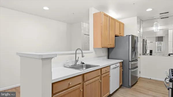 a kitchen with stainless steel appliances a sink and a refrigerator