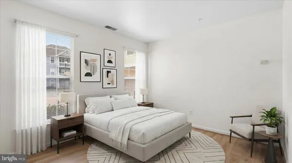 a bedroom with a bed and chair