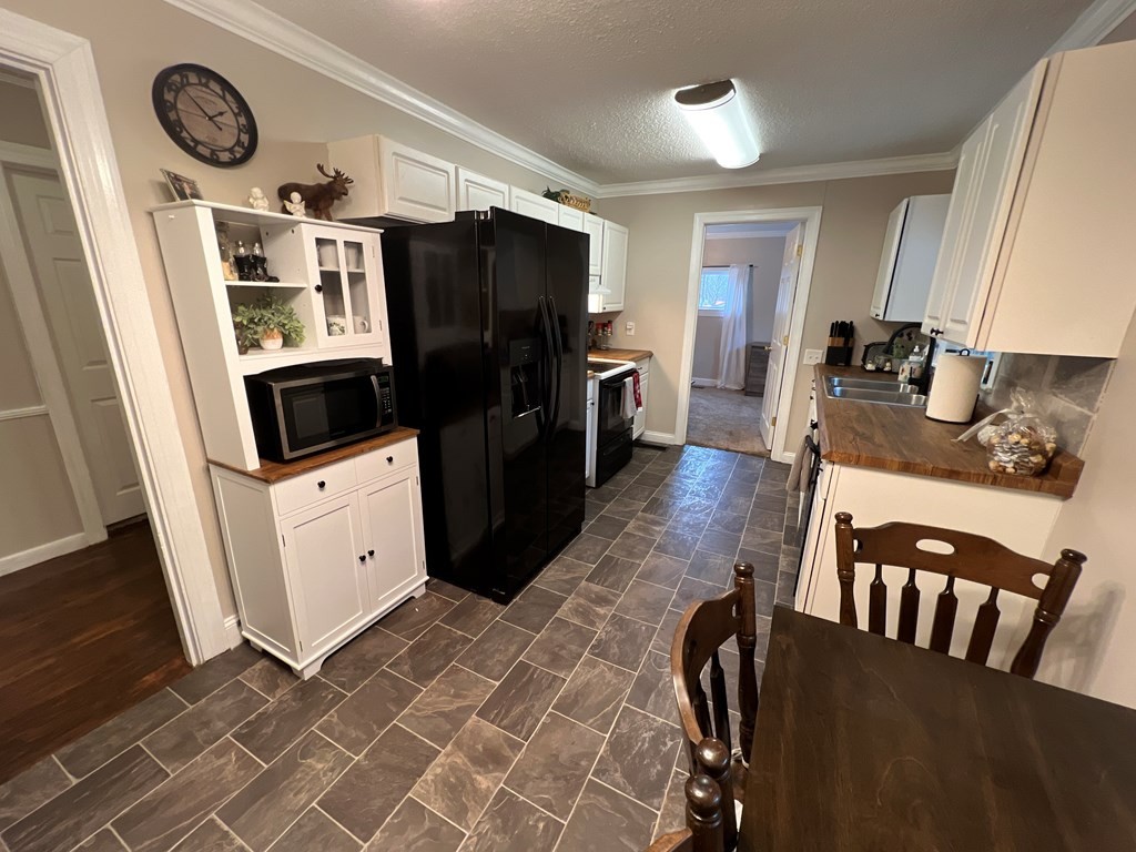 2050 Old River Road Charleston, TN 37310 - Photo 5 of 64 a kitchen with stainless steel appliances granite countertop a refrigerator a stove top oven a sink and dishwasher