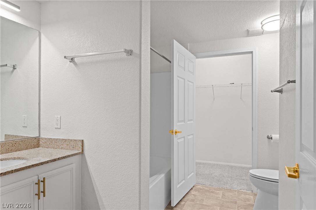 10550 West Alexander Road, Unit 1025 Las Vegas, NV 89129 - Photo 20 of 42 A well-maintained bathroom featuring a vanity with granite counters and a clean, accessible layout.