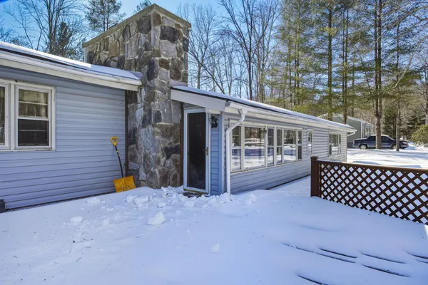 a view of house with backyard and trees
