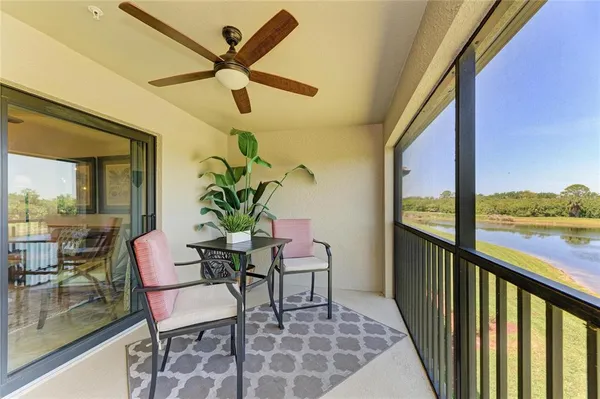 a dining room with furniture and a floor to ceiling window
