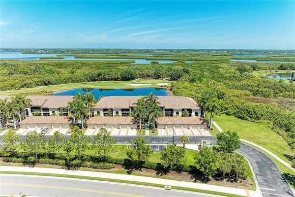 an aerial view of a building with garden space and ocean view