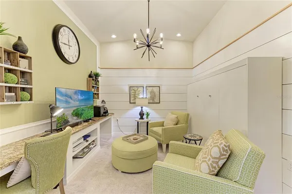a living room with furniture and a wall painting