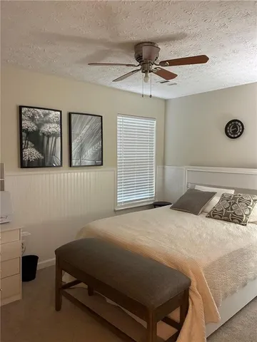 a bedroom with a bed and window