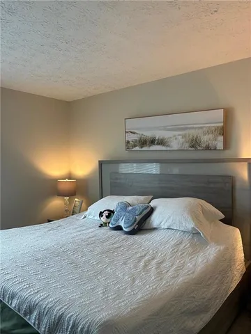 a bedroom with a bed and lamp