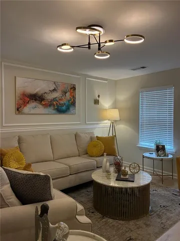 a living room with furniture and a painting