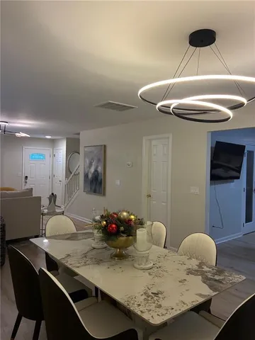 a kitchen with a table chairs and a stove