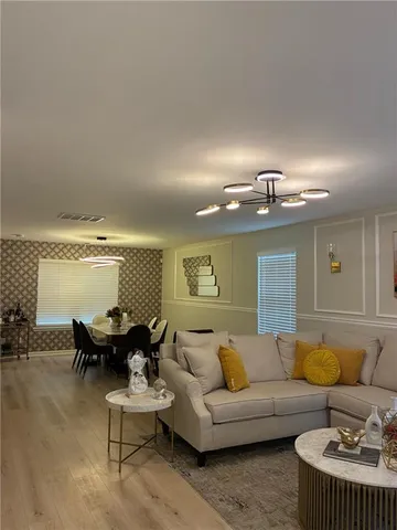 a living room with furniture and a large window