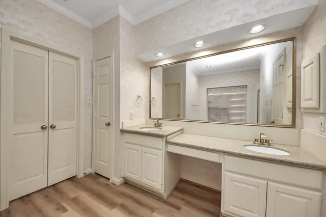 a bathroom with double sink and a mirror