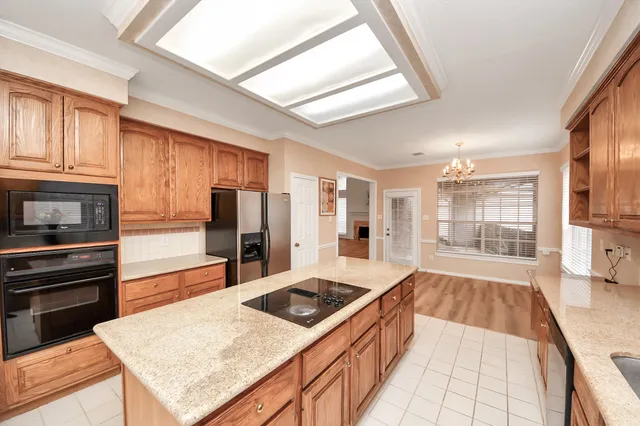 a kitchen with stainless steel appliances granite countertop a stove and a refrigerator